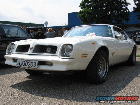 White 1977 Pontiac Firebird coupe, front 3/4 view, with a black grille and a bird emblem