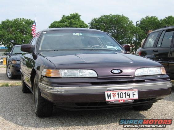 Dark purple 1992 Ford Crown Victoria with a license plate W 1014 F, parked outdoors