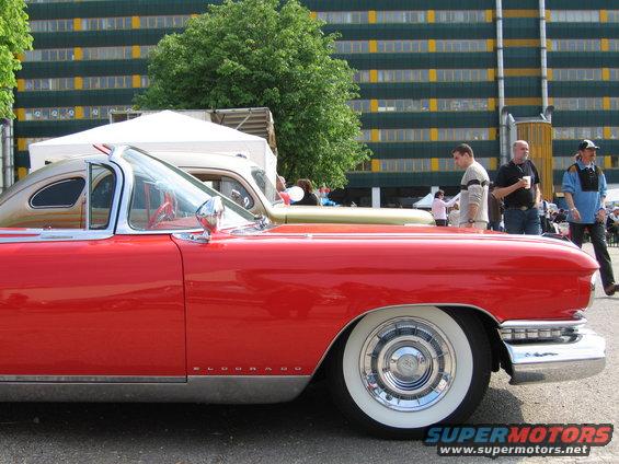 Red 1957 Cadillac Eldorado convertible with whitewall tires, side view