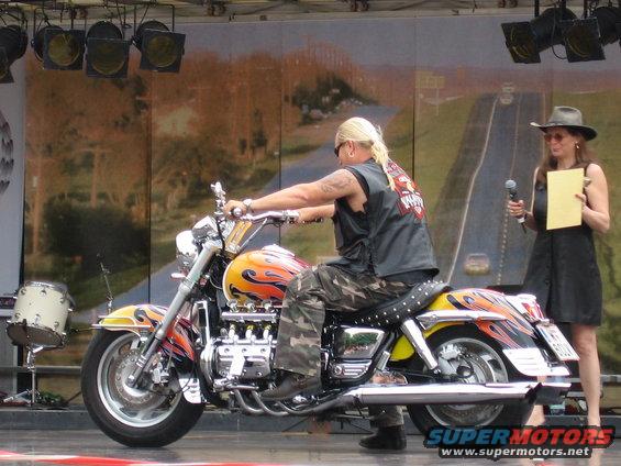 Motorcycle with flame paint job and a man riding it