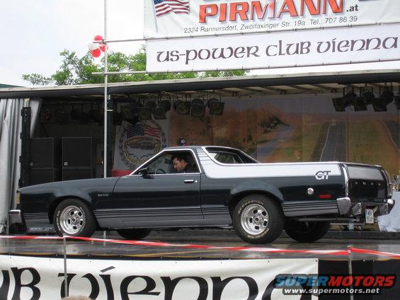 Black and silver Ford Ranchero GT pickup truck on display stage