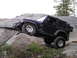 1989 Ford Bronco - Jeep Wrangler TJ navigating a rocky trail, demonstrating off-road capability.