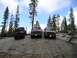 1989 Ford Bronco - A Jeep, a maroon van, and a gray truck are parked on a rocky slope in a forest setting.