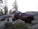 1989 Ford Bronco - Two trucks, a 1989 Ford Bronco and a Dodge Ram, navigate a challenging rocky trail.