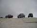 1989 Ford Bronco - A group of off-road vehicles are parked on a rocky outcrop, with a few people standing nearby.