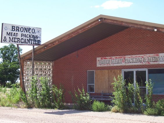 Abandoned Bronco Meat Packing & Mercantile building with weathered sign