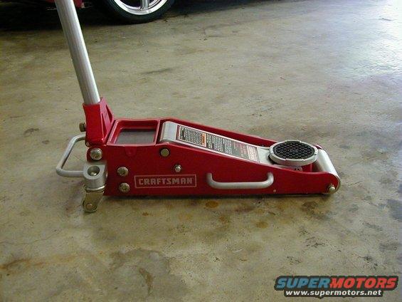 Red Craftsman floor jack on concrete floor