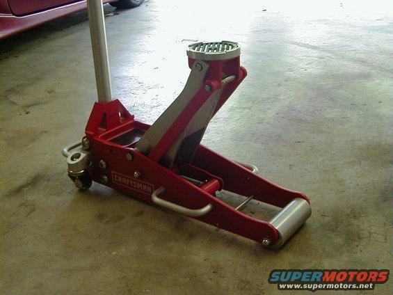 red craftsman floor jack on concrete floor