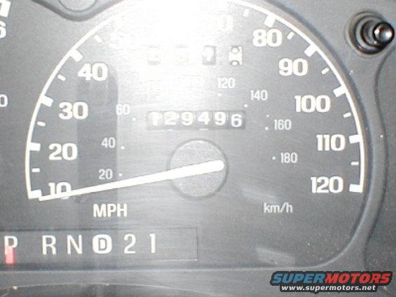 Speedometer shows 129,496 miles. Gear selector shows P R N D 2 1