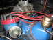 1972 Ford Mustang - The engine bay shows a carburetor and distributor with red spark plug wires.
