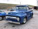 1972 Ford Mustang - A blue 1956 Ford F-series pickup truck is parked outdoors next to another vehicle.