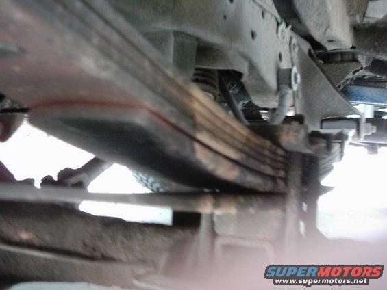 Underside view of vehicle leaf springs and frame components