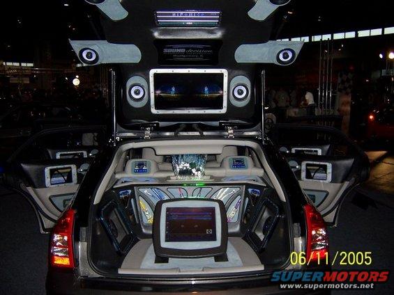 Car trunk modified with multiple speakers, screens, and custom lighting