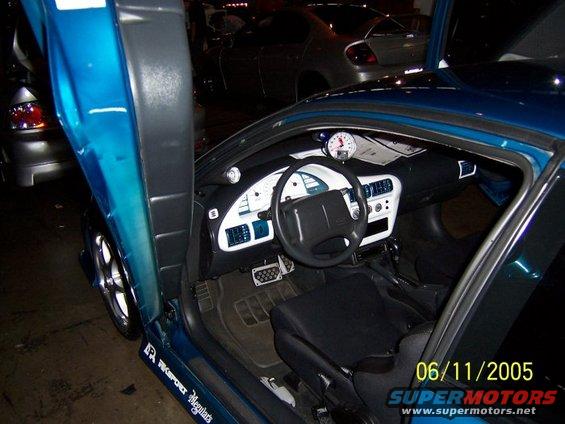 Blue car interior with custom gauges and suicide doors. Date stamp 06/11/2005
