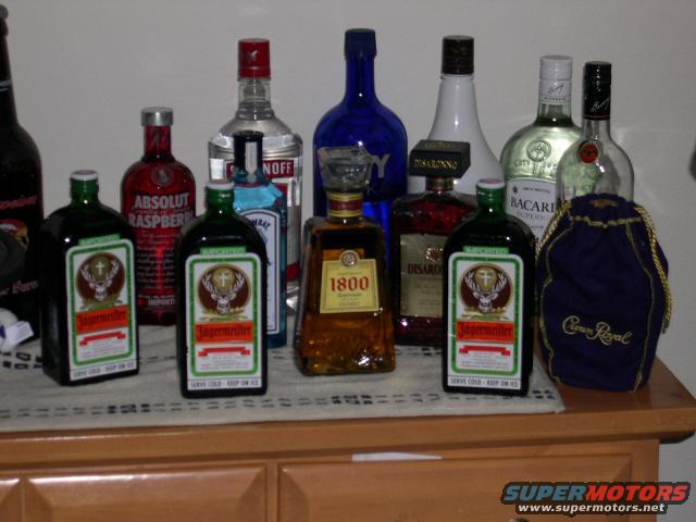 Collection of liquor bottles including J&auml;germeister, Absolut Raspberry, and Crown Royal