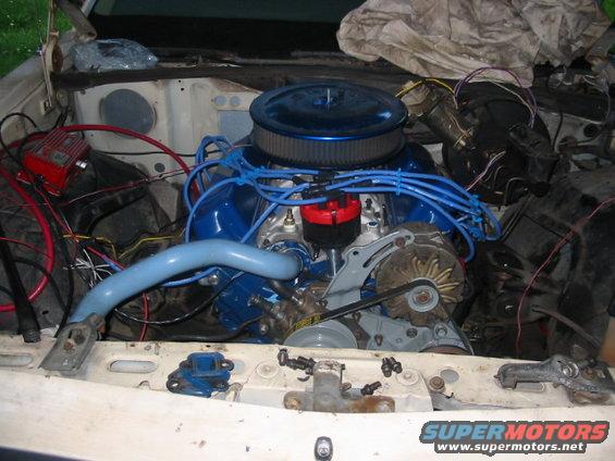 engine bay with blue air cleaner and blue spark plug wires
