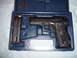 1988 Ford Bronco - A pistol and its magazine are neatly stored in a fitted blue carrying case.