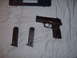 1988 Ford Bronco - A pistol and two magazines are laid out on a white cloth next to a black carrying case.