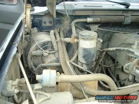 Engine bay with AC components and hoses
