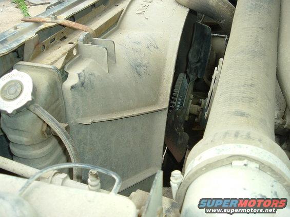Radiator fan and shroud assembly with hoses and coolant cap