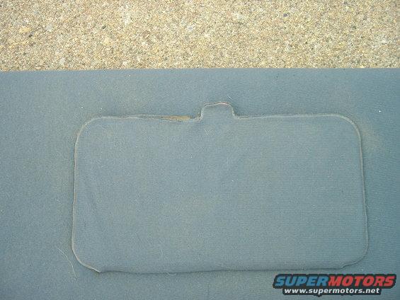 Close-up of a gray interior door panel with a rectangular cutout and a tab at the top. Supermotors.net logo visible