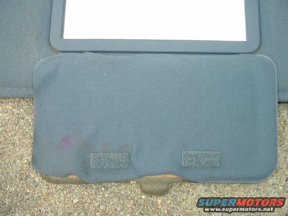 Car sun visor with mirror, showing some stains and velcro strips
