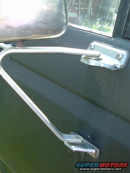 Side mirror arm and mount on a dark vehicle
