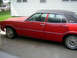 1974 Ford Maverick - This 1974 Ford Maverick sedan features a red exterior and a black vinyl roof, viewed from the side.