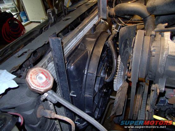 img_0049.jpg A quick trial fit before shortening the angle iron to fit and weld the strap steel tabs that will hold it to the upper rad support( via 2 screws).  Note there's plenty of room to fit the elctric fan without pulling the stock mechanical clutch fan.