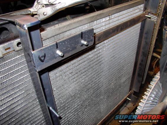 img_0056.jpg Here you can see the way the strap steel will allow a couple of screws will secure the whole assembly to the upper rad support, and keep it close to the rad.