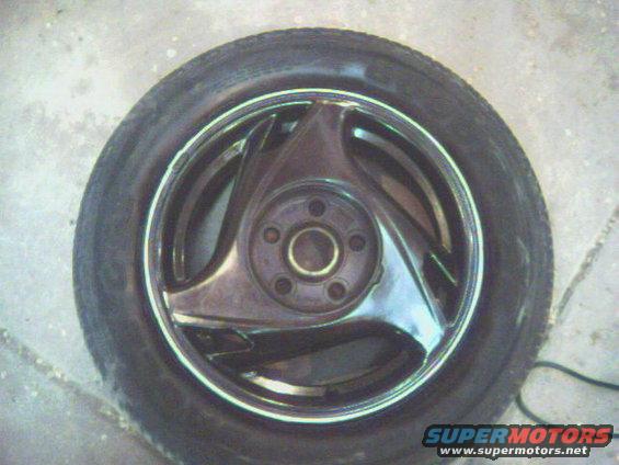 Chrome alloy wheel with three spokes and a tire