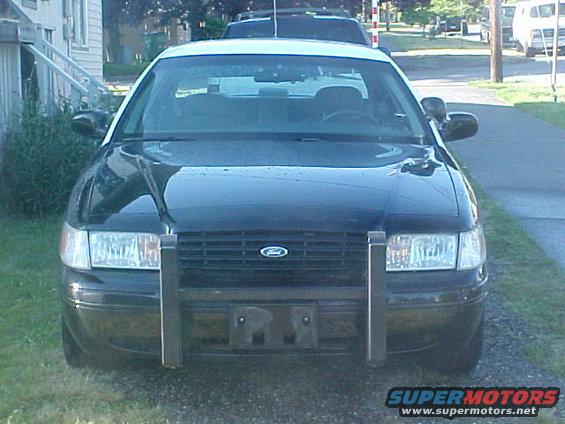 Front view of a 1999 Ford Crown Victoria police car with a push bumper