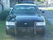 1999 Ford Crown Victoria - This 1999 Ford Crown Victoria police car is seen from the front, equipped with a push bumper and a white roof.