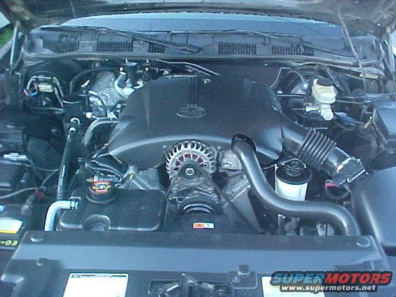 Engine bay of a 2000 Ford Crown Victoria, showing the V8 engine, alternator, and air intake system