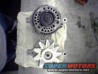 Two automotive alternators, one larger than the other, resting on a white cloth