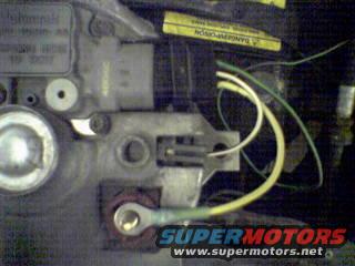 Alternator wiring harness and terminals. Yellow and white wires connect to a gray plug