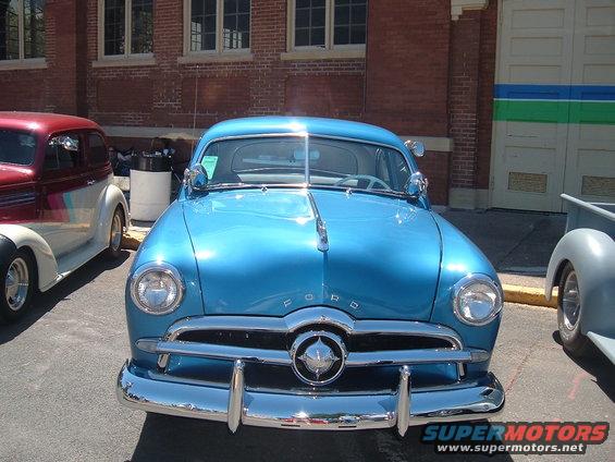 Blue classic Ford coupe front view with chrome grille and headlights