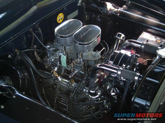 Engine bay with dual Edmunds carburetors, chrome alternator, and black wiring
