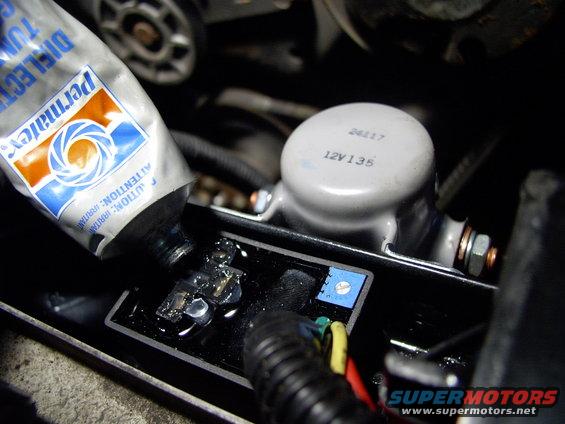 img_0118.jpg Stuffing the relay sockets on the adjustable controller full of dielectric grease. Great shot of adjustable white slot inside the blue square.