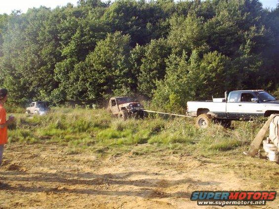 White pickup truck seen from the side at an outdoor gathering