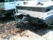 1991 Ford Bronco - The front of a severely damaged vehicle is visible, with debris scattered around it.