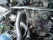 1986 Mazda RX-7 - Close-up view of a modified engine bay, highlighting the turbocharger and associated plumbing.