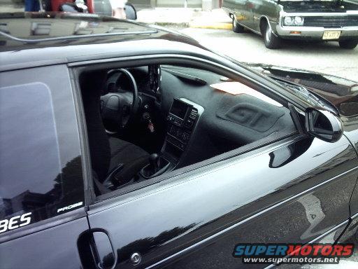 Black 1995 Ford Probe GT interior with dashboard, steering wheel, and gear shift visible