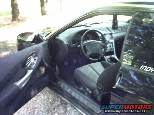 Interior of black car with "INDY" sticker on window