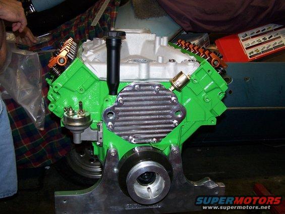 Green V8 engine block with chrome oil pan and orange valve covers