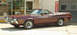 1972 Ford Ranchero - A maroon 1972 Ford Ranchero is parked outside a business with a "Muffler Man" sign visible.