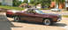 1972 Ford Ranchero - Maroon 1972 Ford Ranchero with aftermarket wheels parked outdoors.
