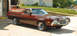 1972 Ford Ranchero - A maroon 1972 Ford Ranchero is parked in front of an open garage door, with an orange pickup truck visible inside.