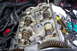 1997 Ford Probe - Close-up of an engine's internal components with the valve cover removed, tools nearby.