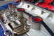 1997 Ford Probe - Close-up of a valve cover gasket with red seals and oil residue, showing internal engine components.